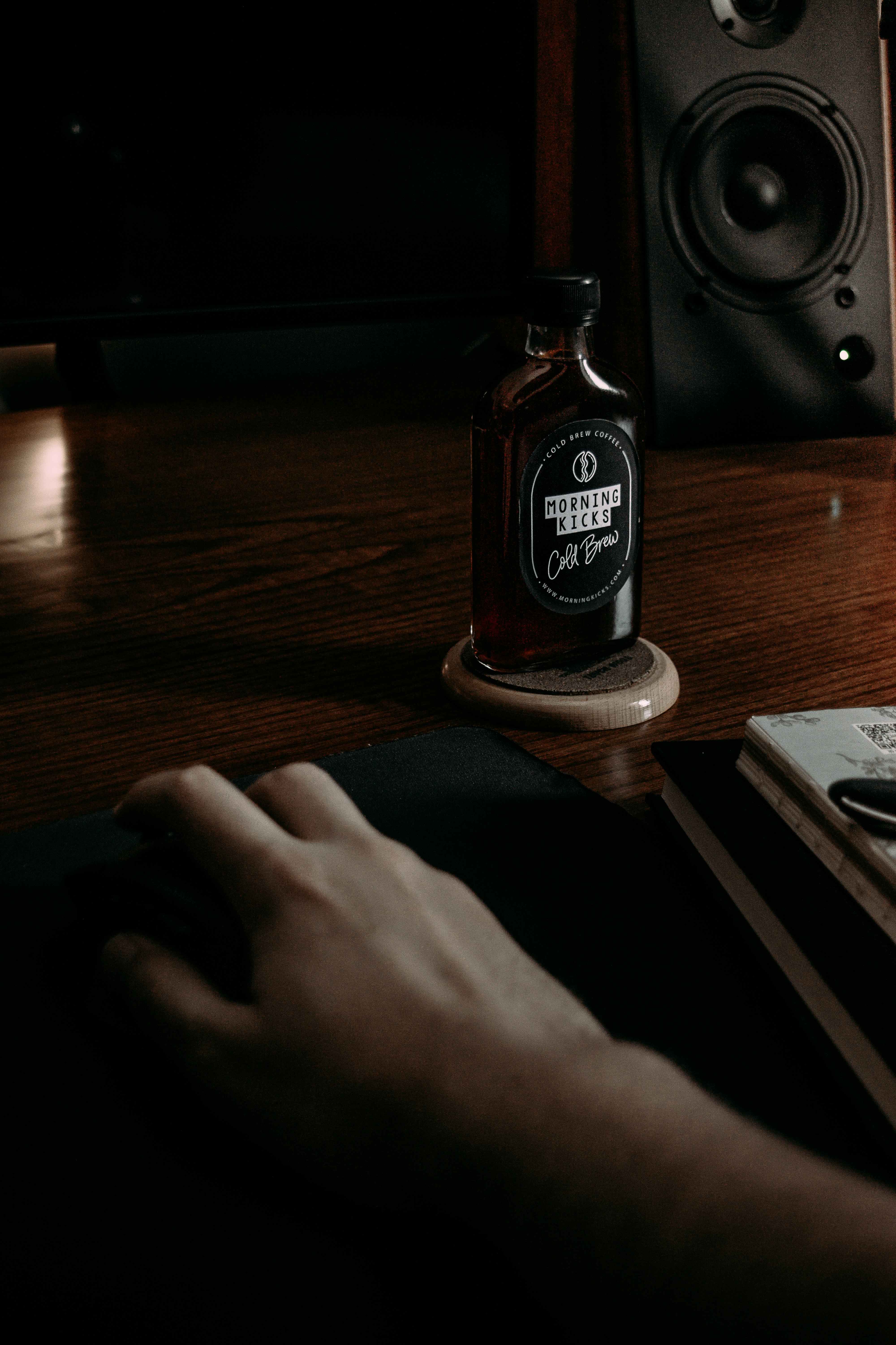 person holding a brown glass bottle